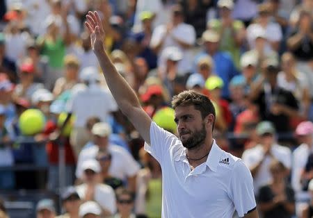 Gilles Simon of France waves after his win over David Ferrer of Spain during their match at the 2014 U.S. Open tennis tournament in New York, August 31, 2014. REUTERS/Eduardo Munoz