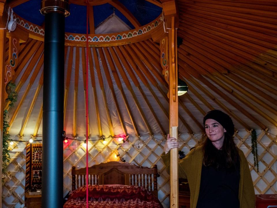 Chris Heijmans stands in her yurt.