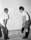<p>Interned Japanese men read President Roosevelt’s proclamation on their evacuation, posted on the wall at Rohwer Relocation Center near McGehee, Ark., Sept. 21, 1942. (AP Photo/Horace Cort) </p>