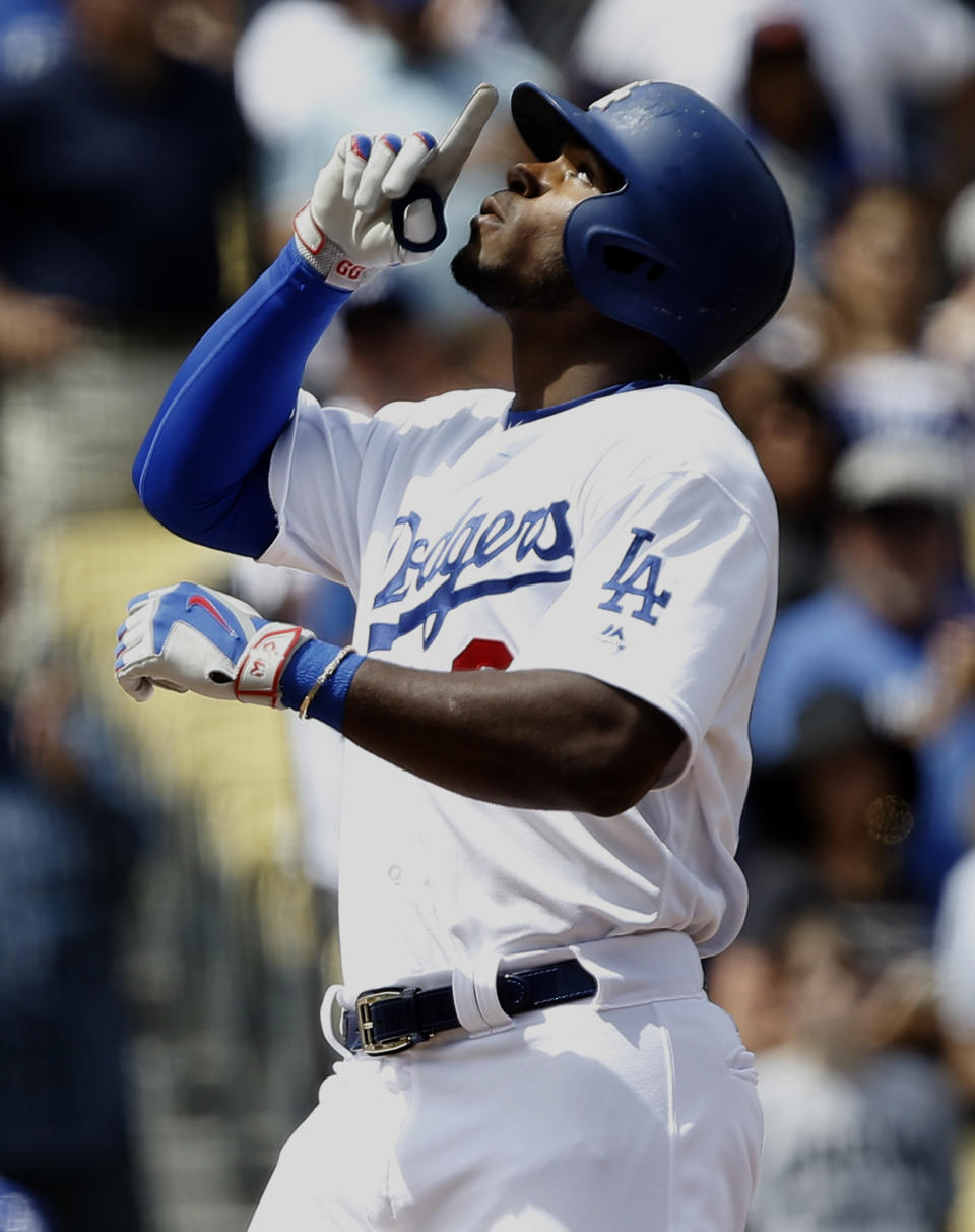 Los Angeles Dodgers' Yasiel Puig points to the sky at the plate after hitting a two-run home run against the San Diego Padres during the second inning of a baseball game in Los Angeles, Thursday, April 6, 2017. (AP Photo/Alex Gallardo)
