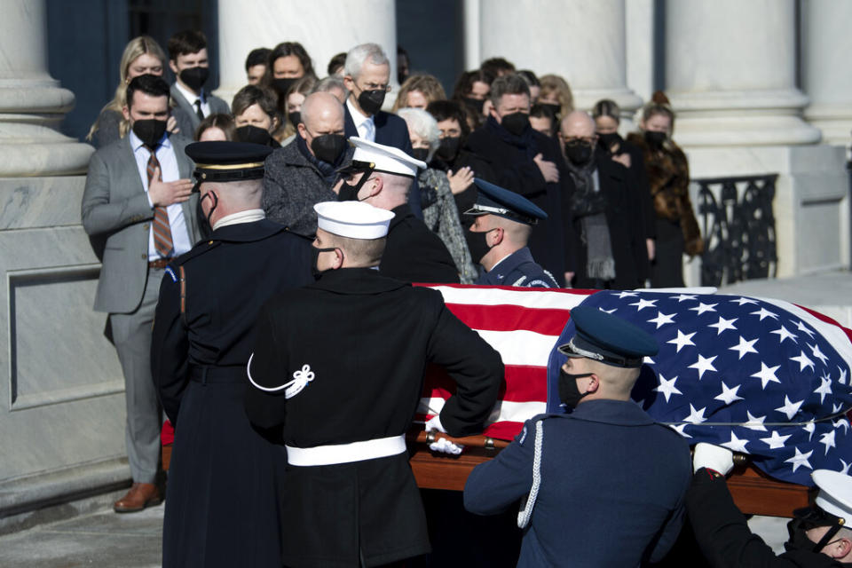 Family members including Josh Reid, Rory Reid and Sen. Harry Reid's wife, Landra Gould, watch as a U.S. Joint Forces bearer team carries the flag-draped casket of former the former Senate majority leader from Nevada into the U.S. Capitol. Reid, who served five terms in the Senate, was honored Wednesday in the Capitol Rotunda during a ceremony closed to the public under COVID-19 protocols. (Brendan Smialowski/Pool via AP)<br>