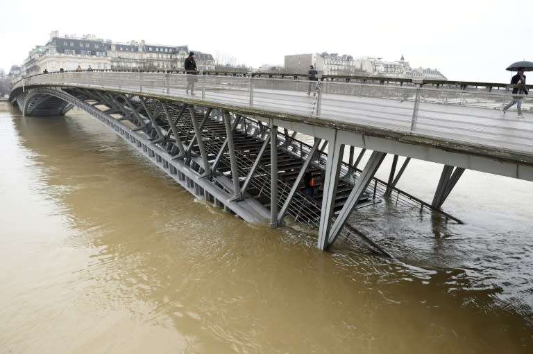 The Seine in Paris has grown into a powerful muddy torrent that has submerged riverside parks and footpaths