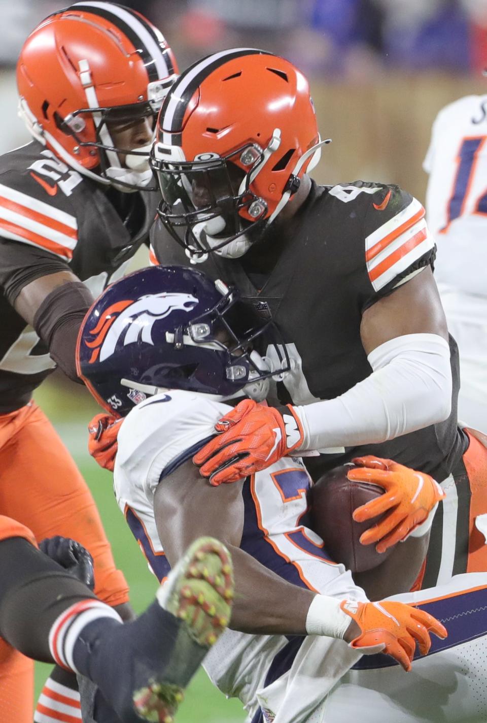 Cleveland's Anthony Walker Jr. takes down Denver's Javontae Williams on Thursday, Oct. 21, 2021 in Cleveland, at FirstEnergy Stadium. The Browns won the game 17-14. [Phil Masturzo/ Beacon Journal]