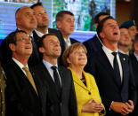 European Union leaders react to a drone filming their group photograph at the European Union leaders summit in Brussels, Belgium December 14, 2017. REUTERS/Phil Noble