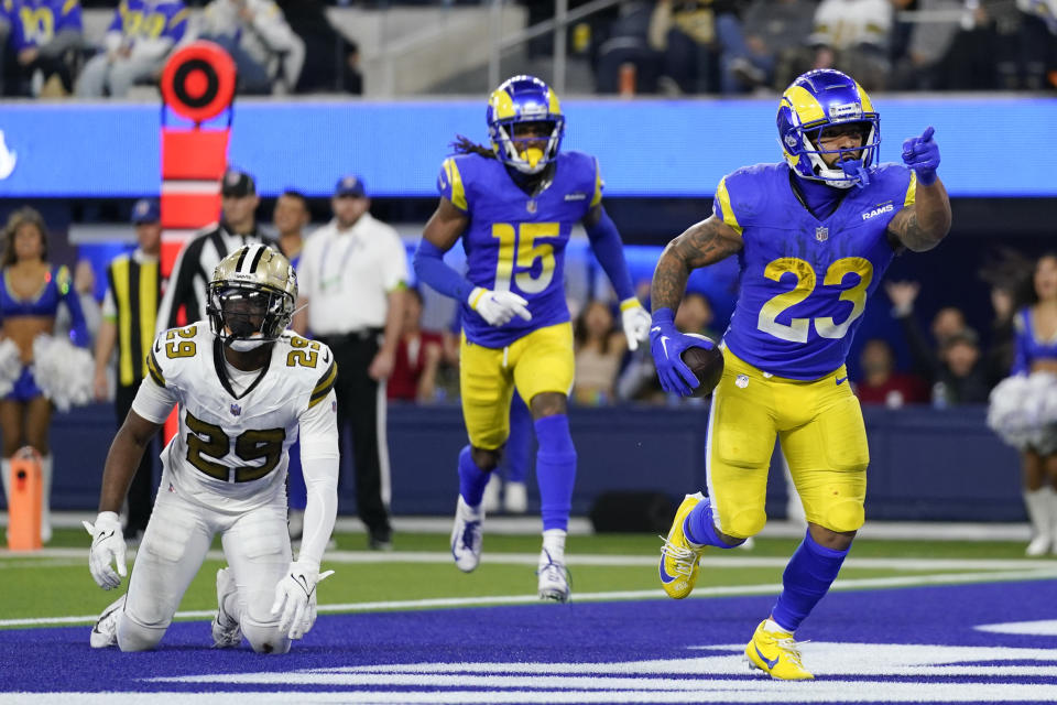 Los Angeles Rams running back Kyren Williams (23) celebrates after his rushing touchdown past New Orleans Saints cornerback Paulson Adebo (29) during the second half of an NFL football game Thursday, Dec. 21, 2023, in Inglewood, Calif. (AP Photo/Ashley Landis)
