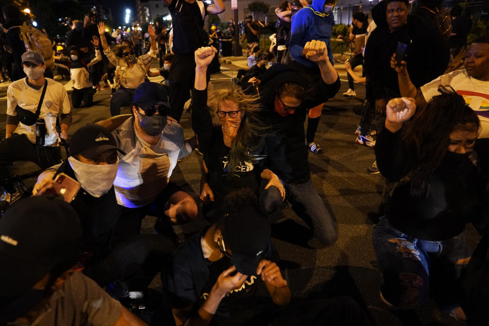 Demonstrators react as a helicopter circles low as people gather to protest the death of George Floyd, Monday, June 1, 2020, near the White House in Washington. Floyd died after being restrained by Minneapolis police officers. (AP Photo/Evan Vucci)