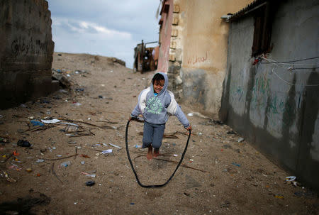 A Palestinian girl plays outside her family's house in Al-Shati refugee camp in Gaza City January 17, 2018. REUTERS/Mohammed Salem