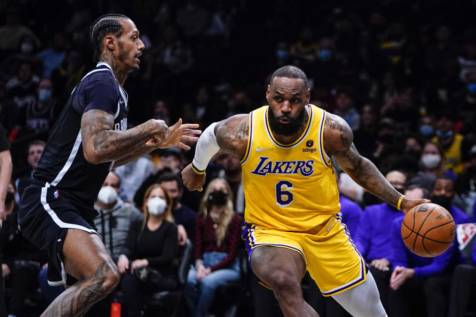 Los Angeles Lakers' LeBron James (6) drives past Brooklyn Nets' James Johnson (16) during the first half of an NBA basketball game Tuesday, Jan. 25, 2022 in New York. (AP Photo/Frank Franklin II)