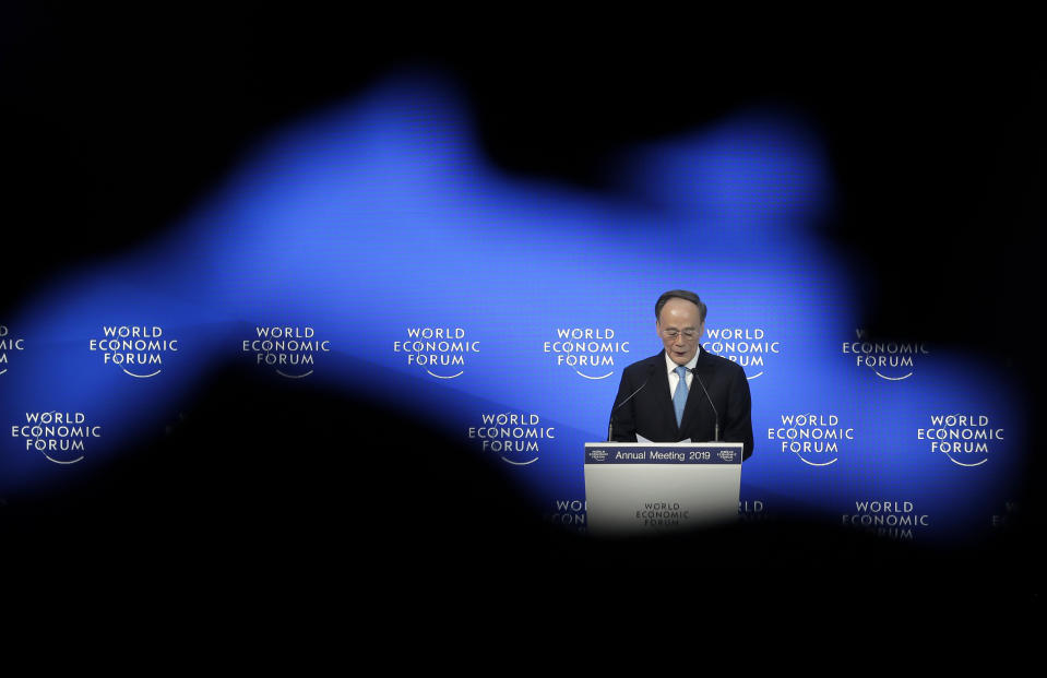 Chinese Vice President Wang Qisan addresses the annual meeting of the World Economic Forum in Davos, Switzerland, Wednesday, Jan. 23, 2019. (AP Photo/Markus Schreiber)