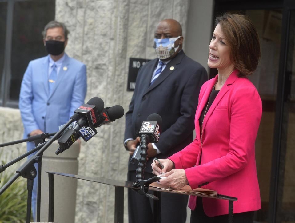 Former District Attorney Meg Heap, right, at a press conference in 2020 in front of the Chatham County Courthouse Wednesday. Mayor Van Johnson, center, and City Manager Pat Monahan listen.