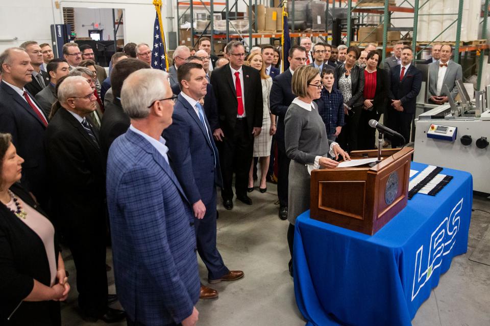 Gov. Kim Reynolds gives remarks before signing the 3.9% flat tax into law, on Tuesday, March 1, 2022, at LBS, a bookbinding and packaging company in Des Moines.