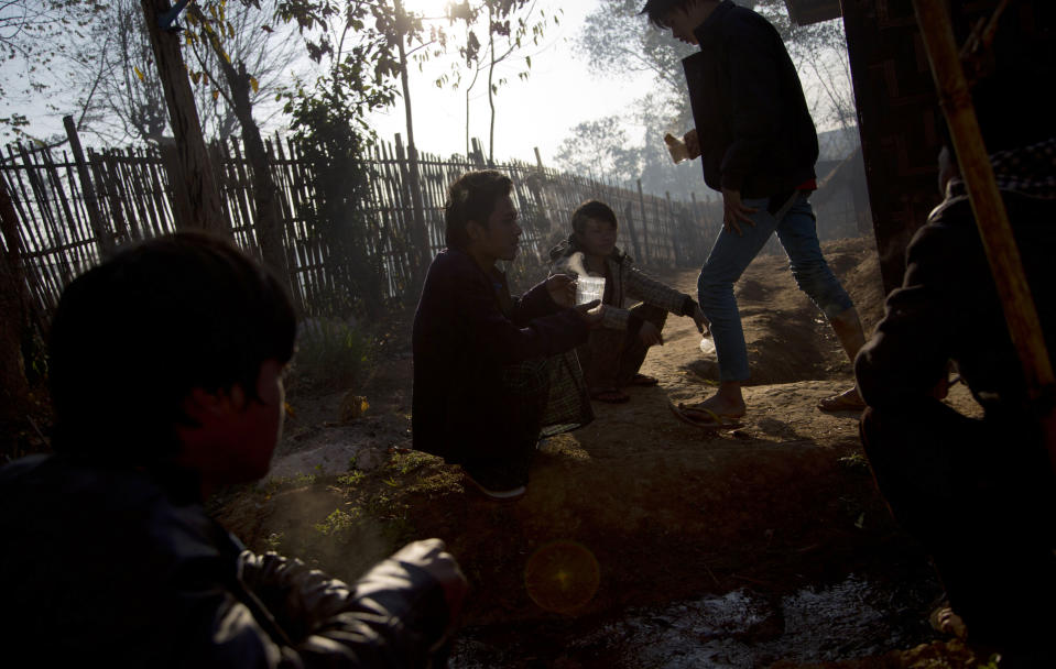 In this Jan 28 photo, young drug addicts gather outdoors for morning tea at a drug rehabilitation center run by the Kachin Baptist Community at Nampatka Village, Northern Shan State, Myanmar. "Every family is affected," said Yaw Htung, Nampakta's village administrator. "Half the population of 8,000 uses. It's not just opium or heroin anymore, but methamphetamines." (AP Photo/Gemunu Amarasinghe)