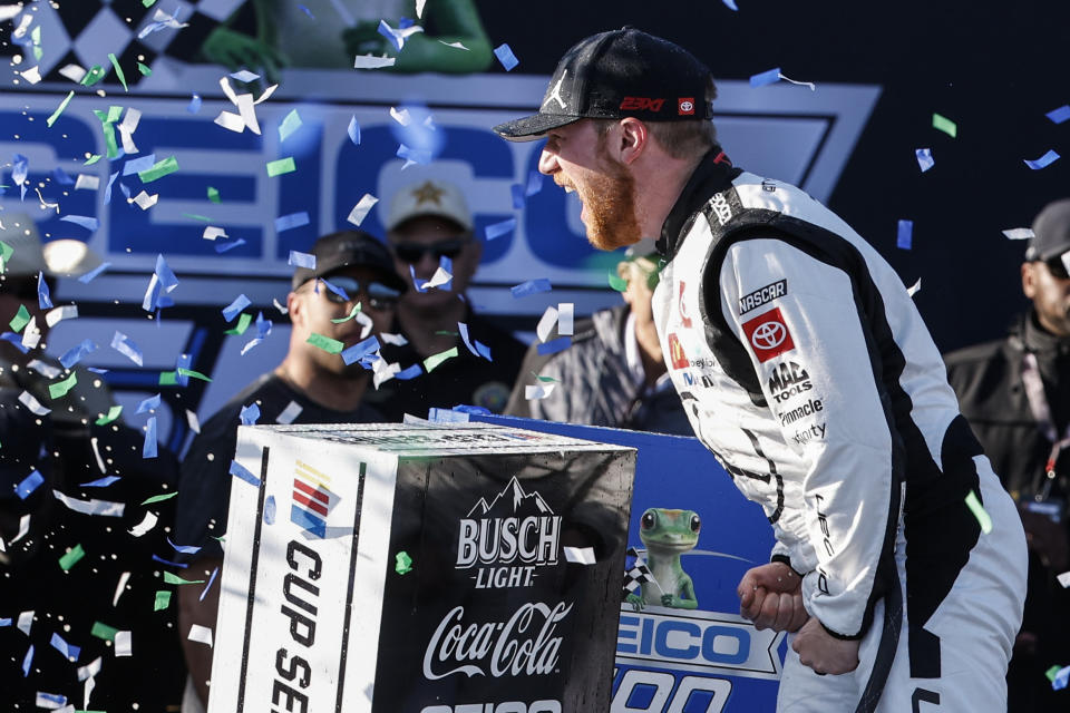 Tyler Reddick celebrates his win at a NASCAR Cup Series auto race at Talladega Superspeedway, Sunday, April 21, 2024, in Talladega. Ala. (AP Photo/Butch Dill)