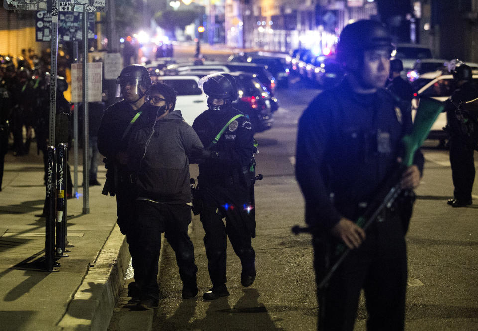 Police officers arrest a protester Sunday, May 31, 2020, in Los Angeles, during a protest over the death of George Floyd, who died May 25 after he was pinned at the neck by a Minneapolis police officer. (AP Photo/Ringo H.W. Chiu)