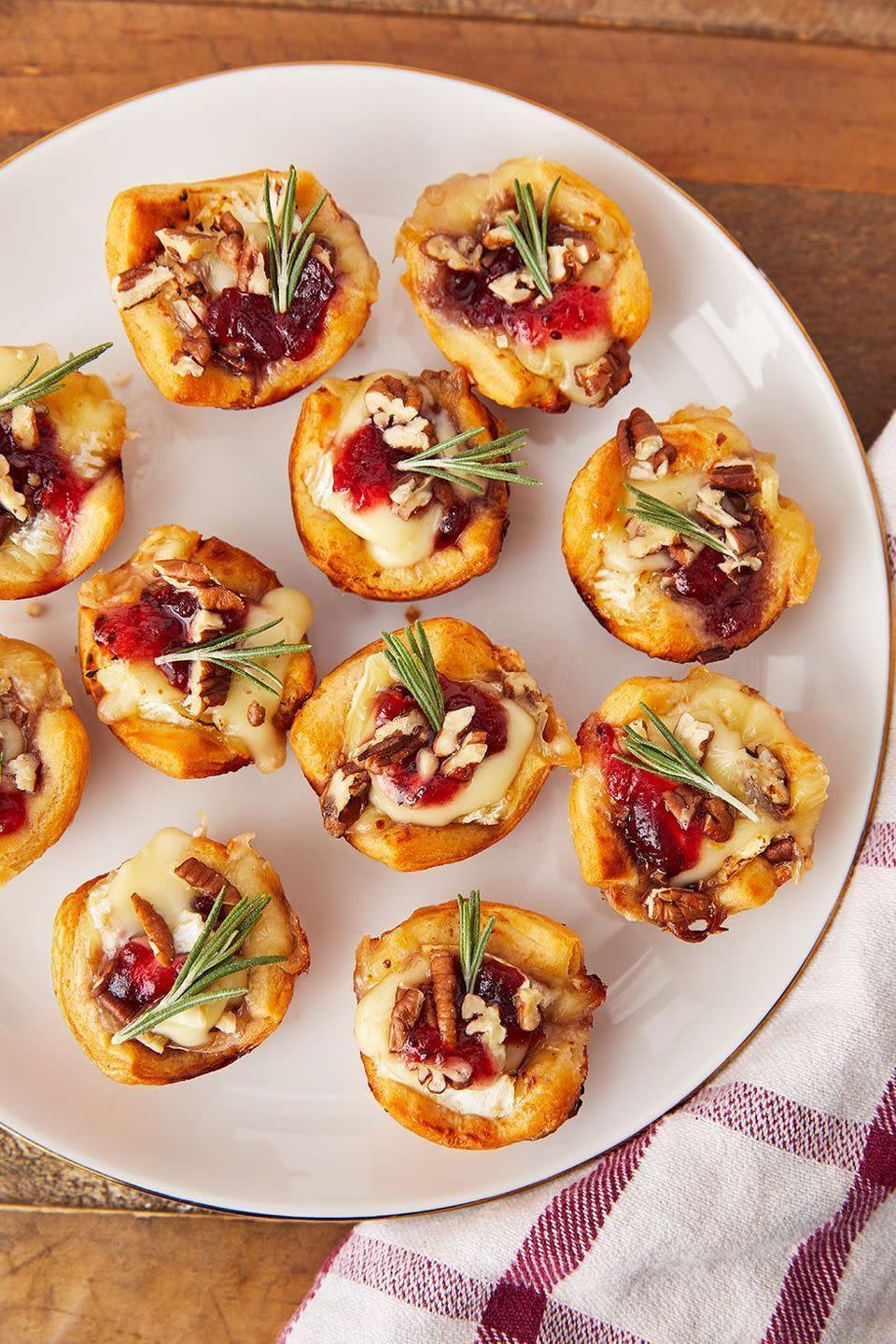 <p>These little guys are the perfect appetiser. Be warned: It'll forever change the way you think about brie. </p><p>Get the <a href="https://www.delish.com/uk/cooking/recipes/a29664090/cranberry-brie-bites-recipe/" rel="nofollow noopener" target="_blank" data-ylk="slk:Cranberry Brie Bites;elm:context_link;itc:0;sec:content-canvas" class="link ">Cranberry Brie Bites</a> recipe.</p>