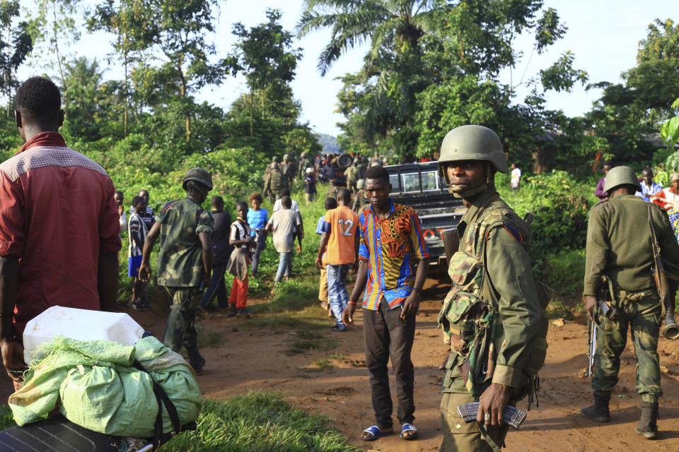 In this photo taken Friday, Oct 5, 2018, Congolese Soldiers patrol in an area civilians were killed by The Allied Democratic Forces rebels in Beni, Eastern Congo. Congo’ military said Sunday Oct. 21, 2018, that rebels attacked an Ebola treatment centre in Beni, leaving over a dozen civilians dead and abducted about a dozen children, which could force crucial virus containment efforts to be suspended in the area. (AP Photo/Al-hadji Kudra Maliro)