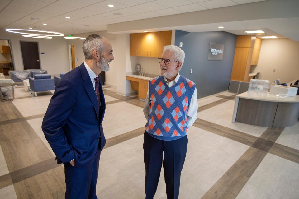 Eric Carney, president and CEO of Monmouth Medical Center,  speaks to Sheldon Vogel, 90, the former CFO of Atlantic Records who is donating millions to Monmouth Medical Center for a new family care center at the Monmouth Mall, inside the Anne Vogel Family Care and Wellness building in Eatontown, NJ Thursday, February 17, 2022. 