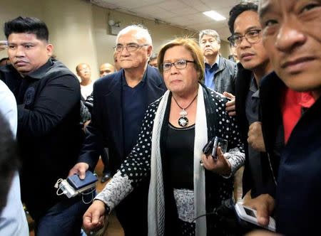 Philippine Senator Leila de Lima is escorted by the Senate's security personnel after a Regional Trial Court (RTC) ordered her arrest, at the Senate headquarters in Pasay city, metro Manila, Philippines February 23, 2017. REUTERS/Romeo Ranoco
