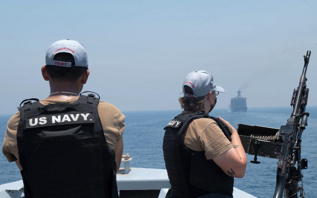 US Navy personnel escort the Mercer Street through the Strait of Hormuz