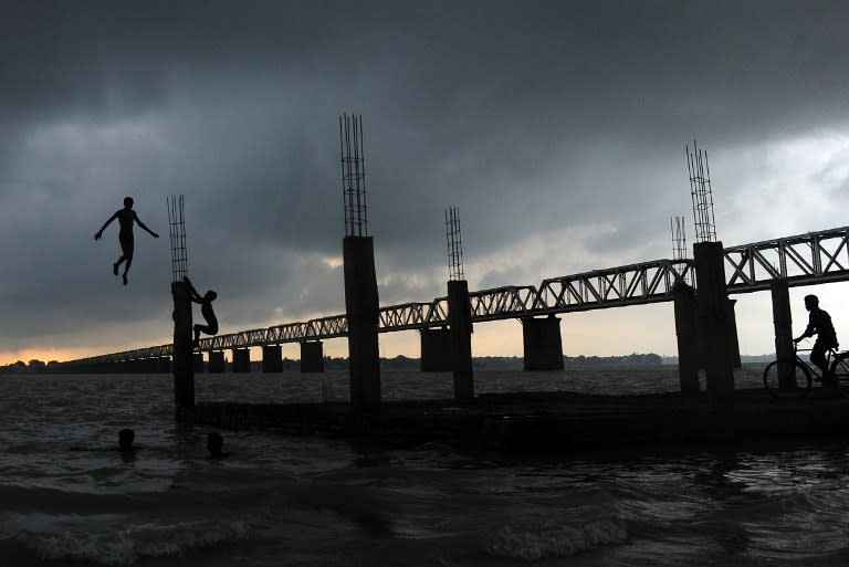 <p>An Indian youth jumps into the flooded river Ganges in Allahabad on July 15, 2016. Water levels in the Ganges and Yamuna rivers have risen after seasonal monsoon rainfall. </p>