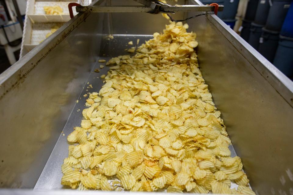 Freshly made chips wait to be placed into containers on Tuesday, Dec. 13, 2022, at Mrs. Fisher's Potato Chips in Rockford.