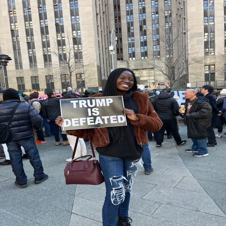 Left, Joanne displays her sign while a Trump supporter plays his guitar outside the courthouse.