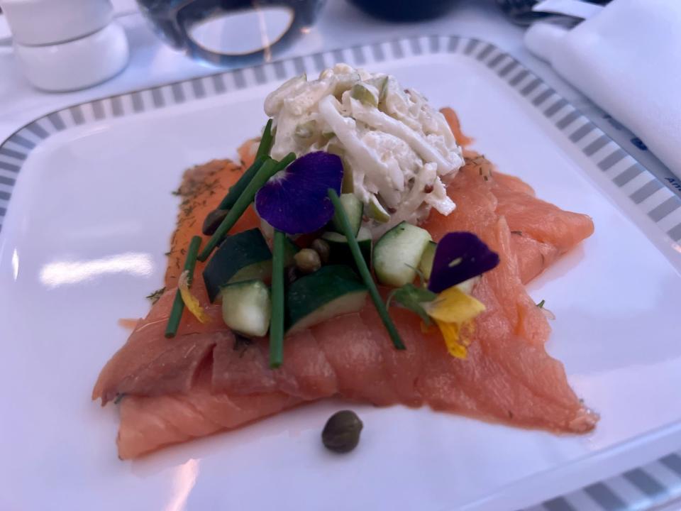 The salmon dish with capers on top.