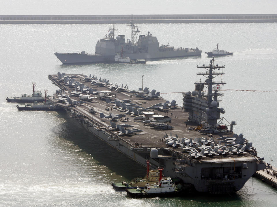 FILE - In this March 22, 2007, file photo, the U.S. aircraft carrier USS Ronald Reagan, bottom, anchors as U.S. Aegis Ship passes after they arrive at Busan port for joint military exercises in Busan, South Korea. China is allowing a U.S. Navy aircraft carrier and its battle group to make a port call in Hong Kong after it turned down similar request amid tensions with Washington. The Marine Department’s website listed the USS Ronald Reagan and three other Navy warships as approved to arrive on Wednesday. (AP Photo/ Lee Jin-man, File)