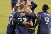 Chicago Fire defender Francisco Calvo (5) hugs forward Robert Beric (27) in celebration of Beric's goal against the New England Revolution during the first half of an MLS soccer match in Chicago, Saturday, April 17, 2021. (AP Photo/Mark Black)