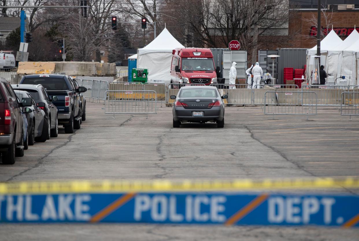 Cars line up as drive-through coronavirus testing for medical workers and first responders opens on March 22, 2020, outside a Walmart in Northlake.