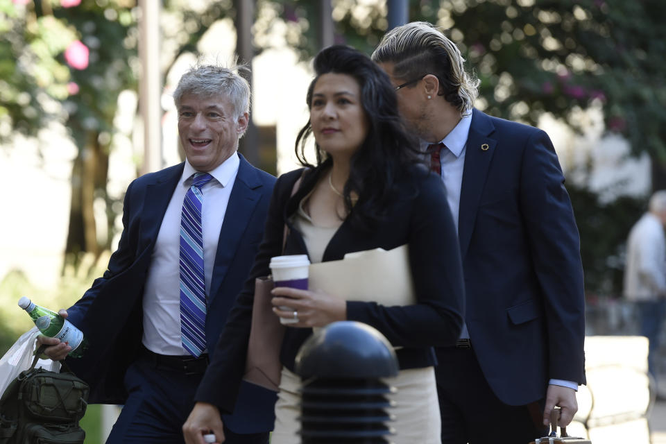 St. Michael's founder and CEO Michael Voris, left, and Milo Yiannopoulos, partially blocked, walk into the federal courthouse, Thursday, Sept. 30, 2021, in Baltimore. U.S. District Judge Ellen Hollander scheduled a hearing Thursday for the lawsuit that rally planners St. Michael’s Media filed against the city. St. Michael's claims city officials cancelled the Nov. 16 rally because they disapprove of the group's religious message. (AP Photo/Gail Burton)