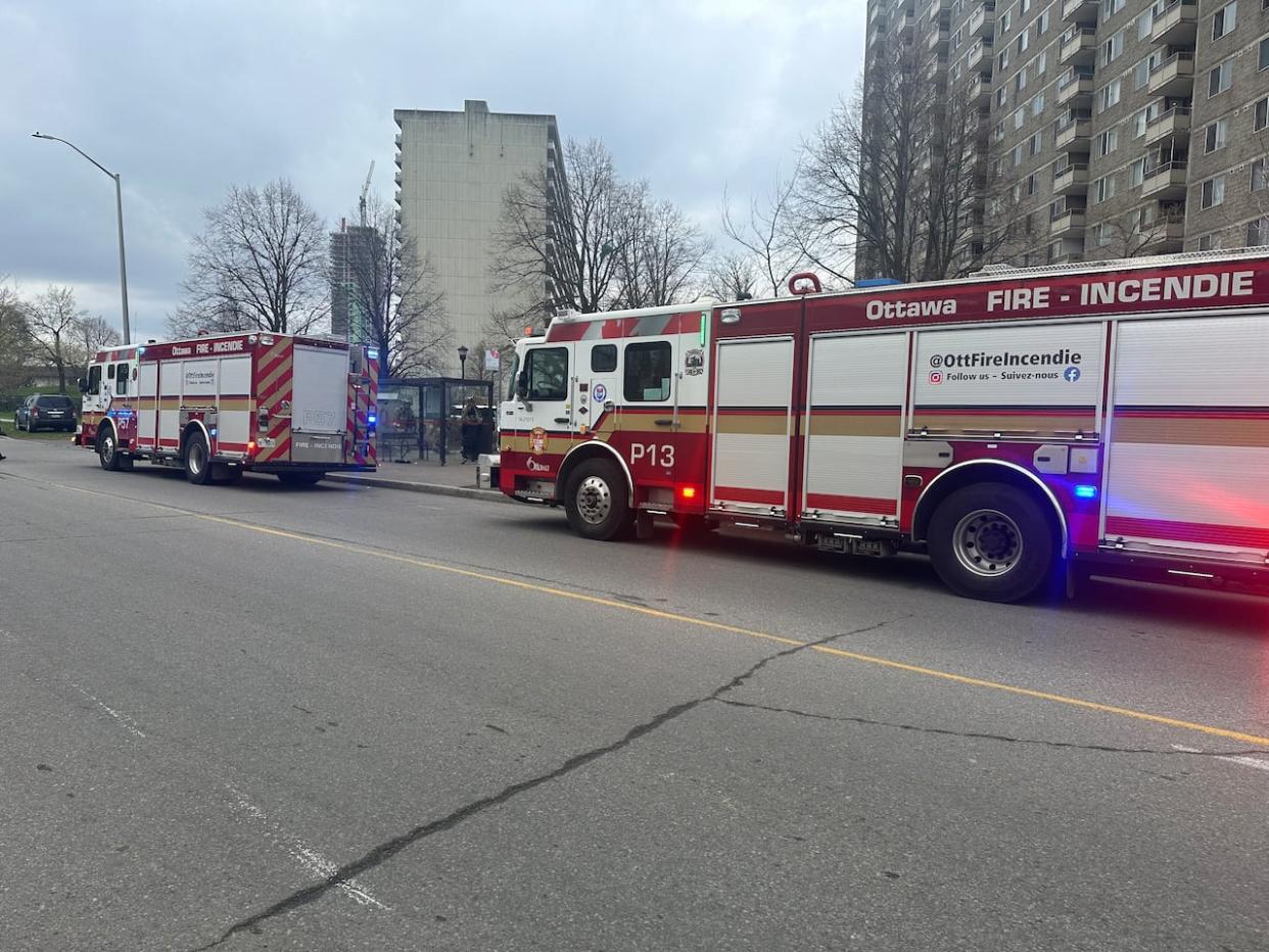 Emergency crews rushed to a highrise on Donald Street after fire broke out Thursday morning. A woman and two children were taken to hospital in critical condition. (Natalia Goodwin/CBC - image credit)