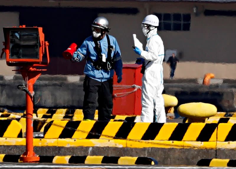Officers in protective gears are pictured at a maritime police's base where people who were transferred from cruise ship Diamond Princess arrived in Yokohama,