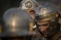 Participants in the Romula Fest historic reenactment event, depicting Roman soldiers prepare for battle in the village of Resca, Romania, Saturday, Sept. 3, 2022. Members of historic NGOs and volunteers gathered in a field outside a southern Romanian village, once part of the Romula Malva, Roman Empire era city, aiming to raise awareness for history through realistic reenactments of battles between Roman legions and local Dacian tribes.(AP Photo/Vadim Ghirda)