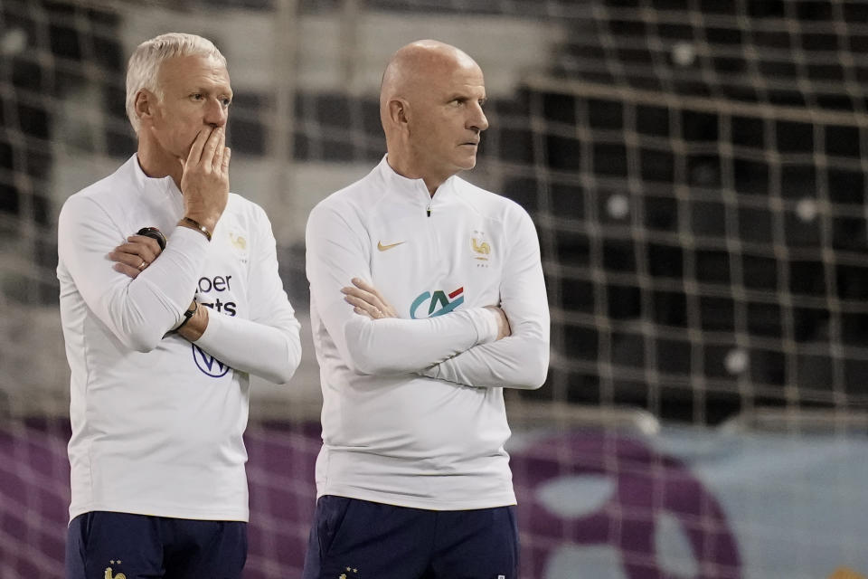 France's head coach Didier Deschamps, left, and assistant coach Guy Stephan supervise during a training session at the Jassim Bin Hamad stadium in Doha, Qatar, Monday, Dec. 12, 2022. France will play against Morocco during their World Cup semifinal soccer match on Dec. 14. (AP Photo/Christophe Ena)
