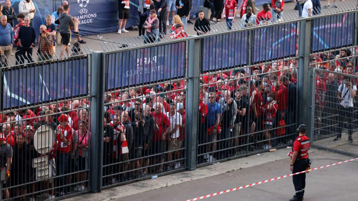 (FILES) In this file photo taken on May 28, 2022, Liverpool fans stand outside unable to get in in time leading to the match being delayed prior to the UEFA Champions League final football match between Liverpool and Real Madrid at the Stade de France in Saint-Denis, north of Paris. - UEFA itself bears 