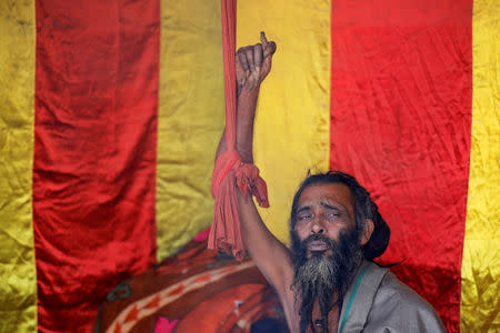 A Sadhu, or Hindu holy man, who has not moved his arm and cut his fingernails for 10 years, sits inside his camp during "Kumbh Mela", or the Pitcher Festival, in Prayagraj, previously known as Allahabad, India, January 17, 2019. REUTERS/Danish Siddiqui