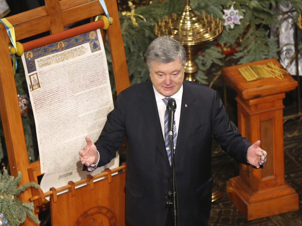 Ukrainian President Petro Poroshenko delivers his speech next to the "Tomos" decree of autocephaly for the Orthodox Church of Ukraine during the service marking Orthodox Christmas and celebrating the independence of the Ukrainian Orthodox Church in the St. Sophia Cathedral in Kiev, Ukraine, Monday, Jan. 7, 2019. (AP Photo/Efrem Lukatsky)