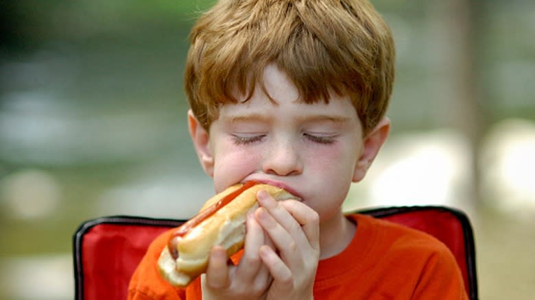 boy eating a hot dog