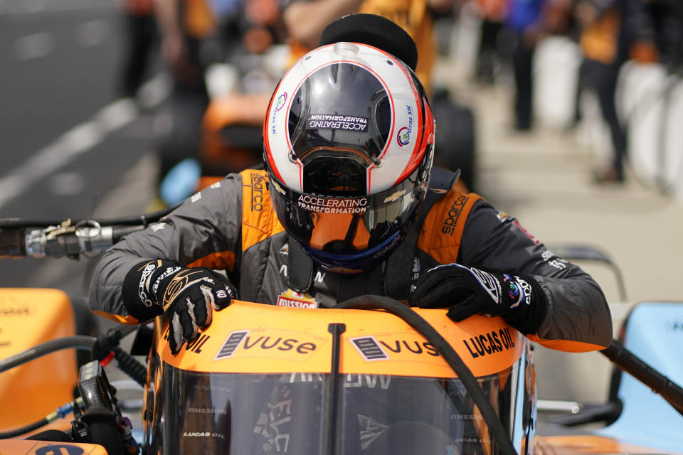 Felix Rosenqvist, of Sweden, climbs into his car during practice for the Indianapolis 500 auto race at Indianapolis Motor Speedway, Thursday, May 19, 2022, in Indianapolis. (AP Photo/Darron Cummings)