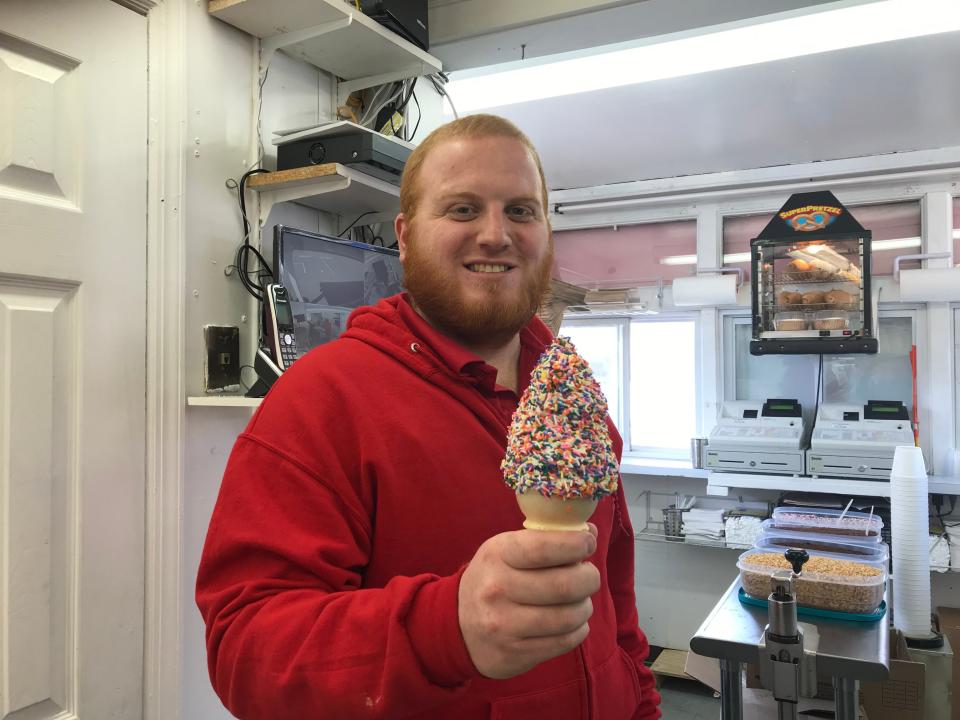 Luke Becker, one of the "four boys," shows off an ice cream cone at Four Boys Ice Cream.
