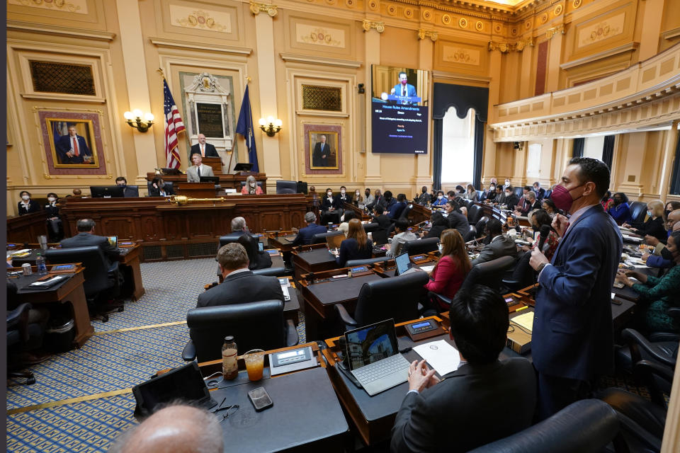 Virginia Del. Marcus Simon, D-Fairfax, right, speaks during the House session at the Capitol Wednesday Feb. 16, 2022, in Richmond, Va. The House passed emergence amendments attached to the school mask bill. (AP Photo/Steve Helber)