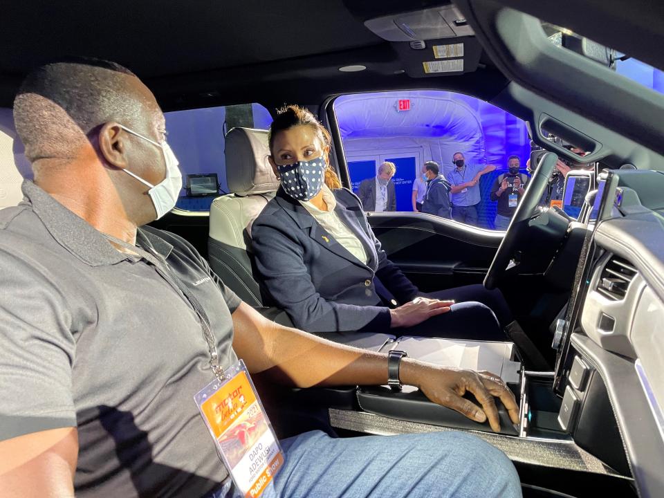 Gov. Gretchen Whitmer learns about the features in the F-150 Lightning from Ford's Dapo Adewusi at MOtor Bella in Pontiac on Tuesday.