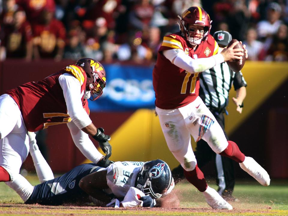 Carson Wentz evades a defender against the Tennessee Titans.