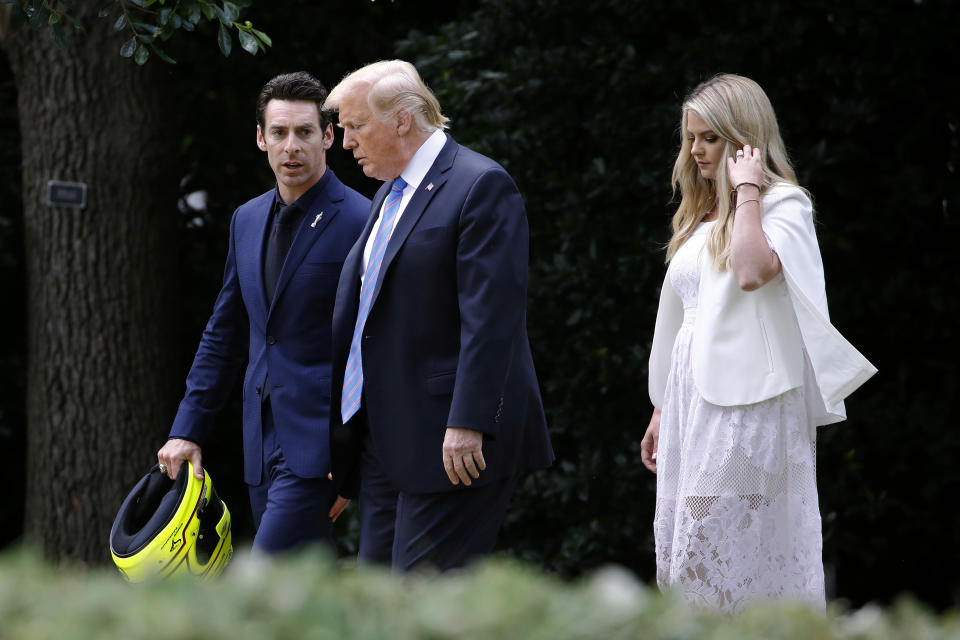 President Donald Trump walks with driver Simon Pagenaud, left, and Pagenaud's fiancee, Hailey McDermott, to the South Lawn at the White House, Monday, June 10, 2019, in Washington for an event to honor Team Penske for the 2019 Indianapolis 500 win. (AP Photo/Patrick Semansky)