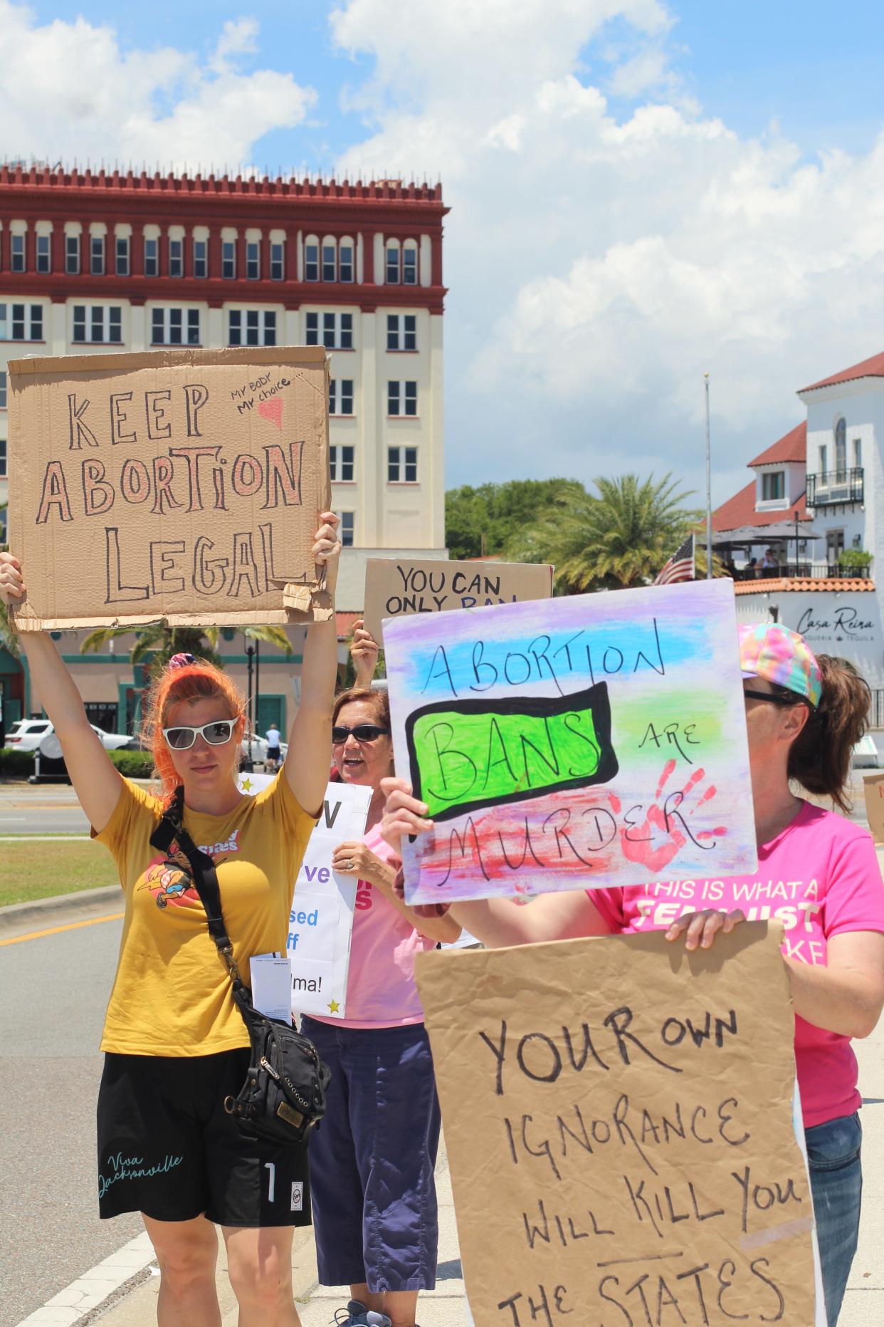 A group of people hold signs in support of abortion rights on Saturday, May 14, 2022, at the base of the Bridge of Lions in St. Augustine.