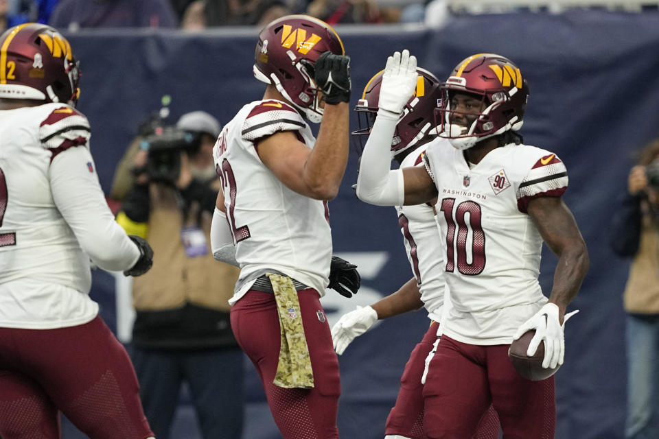 Washington Commanders wide receiver Curtis Samuel (10) celebrates with teammates after he scored a touchdown against the Houston Texans during the first half of an NFL football game Sunday, Nov. 20, 2022, in Houston. (AP Photo/David J. Phillip)