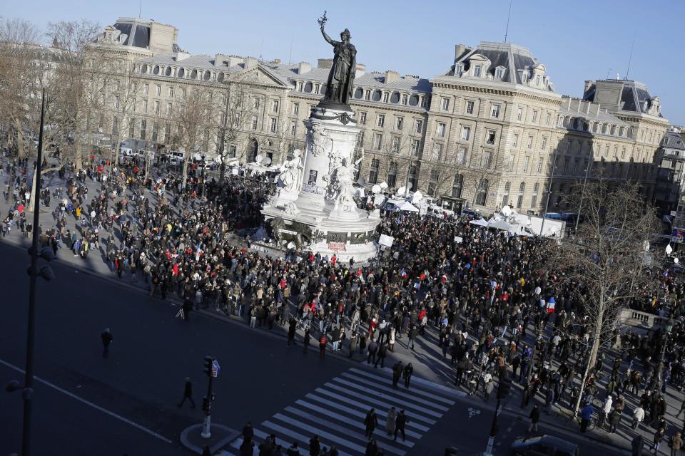 People start gathering at Republique square before the demonstration, in Paris, France, Sunday, Jan. 11, 2015. (AP Photo/Laurent Cipriani)