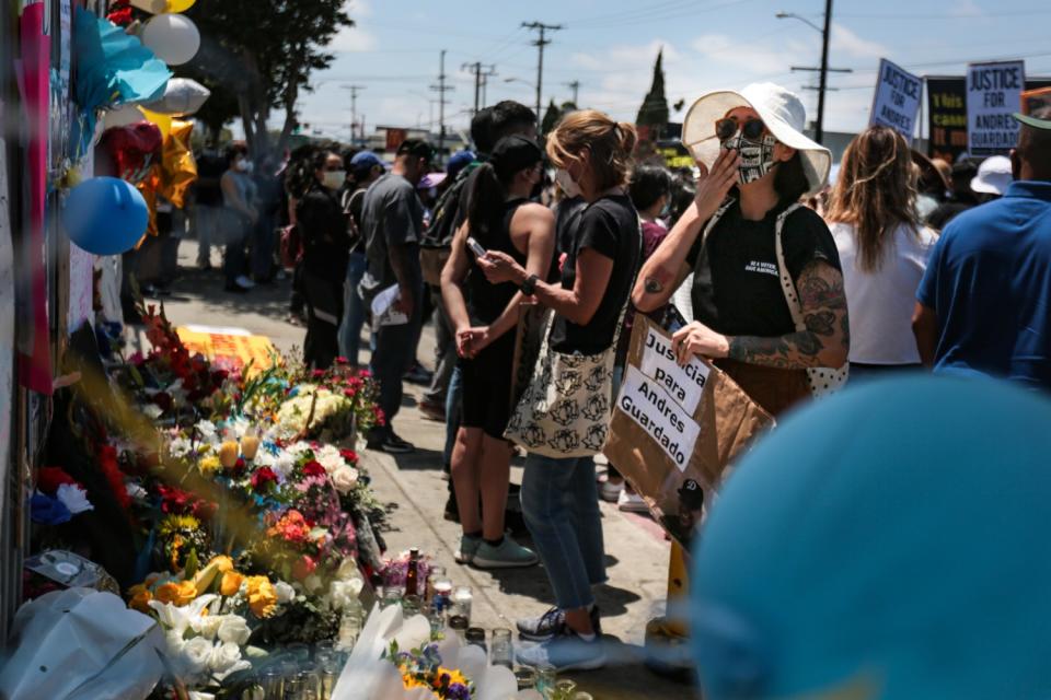 At the rally for Andres Guardado, mourners pay their respects at a makeshift memorial in his honor.