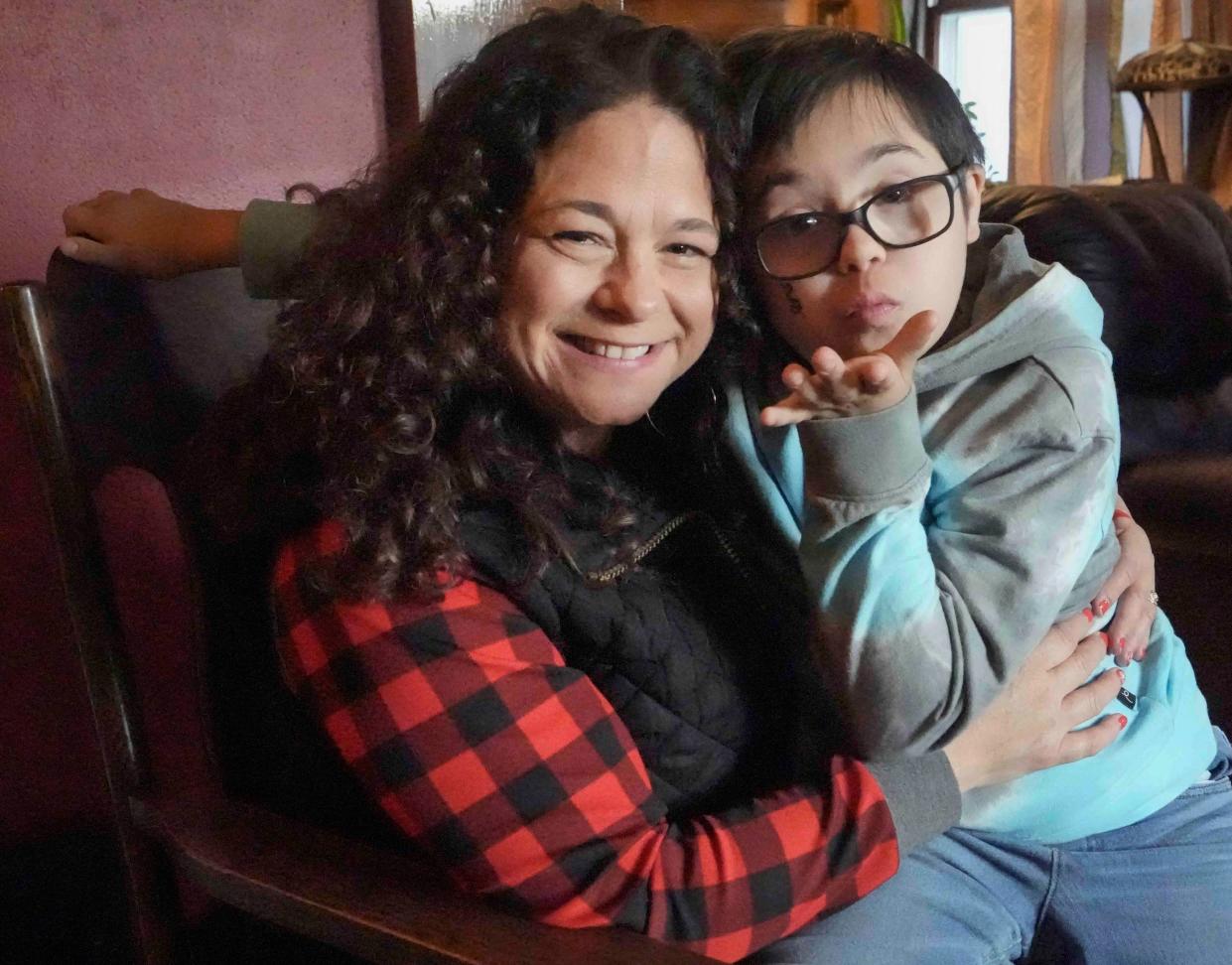 Beth Wisniewski encourages her 11-year-old son, Henry, who has Down syndrome, to use digital technology to improve his conversational skills.